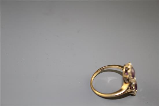 An early to mid 20th century 9ct, amethyst and seed pearl set double cluster dress ring,